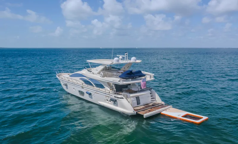 Thinks It's His Too Yacht Photos Pics 2008 Azimut Flybridge yacht on open sea under blue sky.
