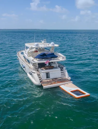 Thinks It's His Too Yacht Photos Pics 2008 Azimut Flybridge yacht on open sea with swim platform extended.