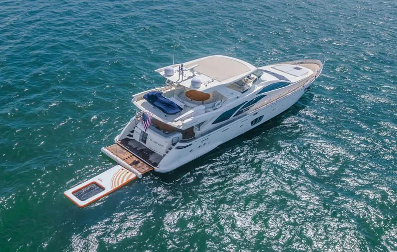 Thinks It's His Too Yacht Photos Pics 2008 Azimut Flybridge yacht cruising on open water, aerial view.