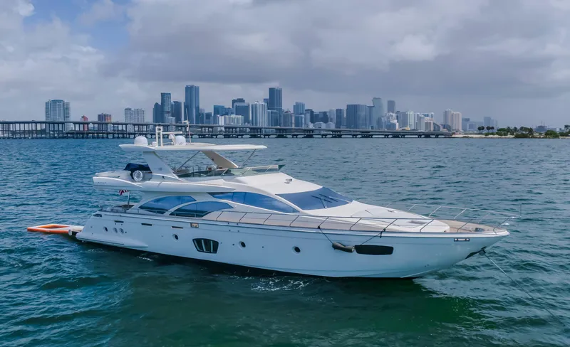 Thinks It's His Too Yacht Photos Pics 2008 Azimut Flybridge yacht cruising near city skyline on a cloudy day.