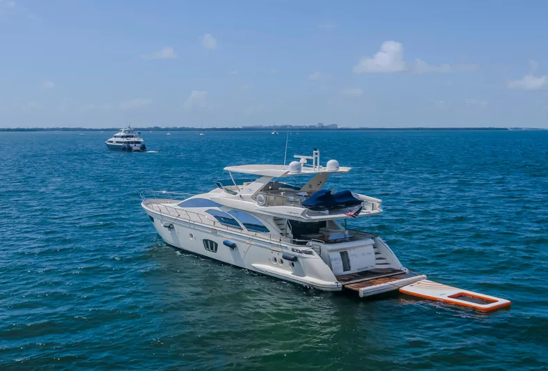 Thinks It's His Too Yacht Photos Pics 2008 Azimut Flybridge yacht on open sea with clear blue skies.