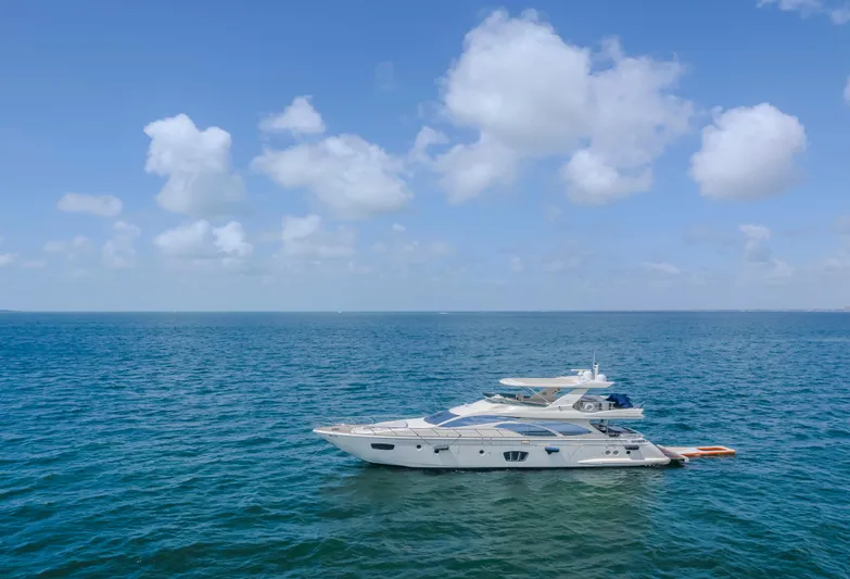 Thinks It's His Too Yacht Photos Pics 2008 Azimut Flybridge yacht on open sea under blue sky.