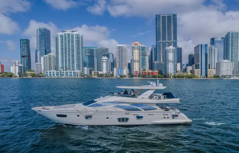 Thinks It's His Too Yacht Photos Pics Azimut Flybridge 2008 yacht cruising near a city skyline on a sunny day.