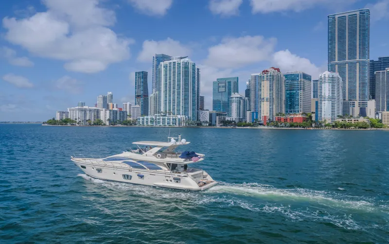 Thinks It's His Too Yacht Photos Pics Azimut Flybridge 2008 yacht cruising near a city skyline on a sunny day.