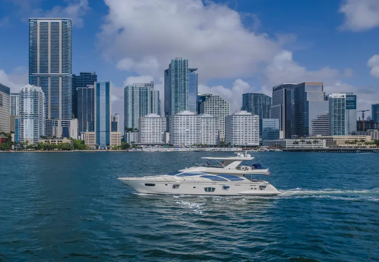 Thinks It's His Too Yacht Photos Pics Azimut Flybridge 2008 yacht cruising near city skyline on a sunny day.