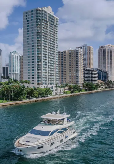 Thinks It's His Too Yacht Photos Pics 2008 Azimut Flybridge yacht cruising near urban waterfront skyscrapers.