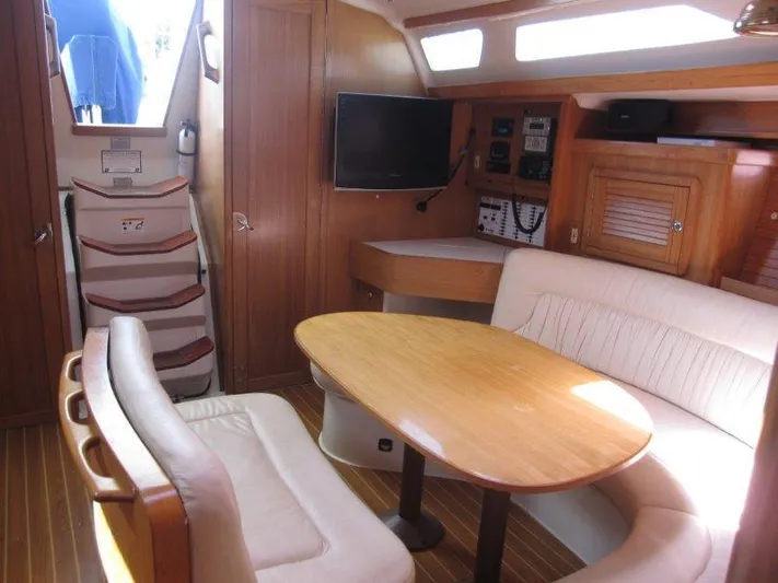  Yacht Photos Pics Interior of 2007 Catalina MkII sailboat with dining area, TV, and navigation equipment.