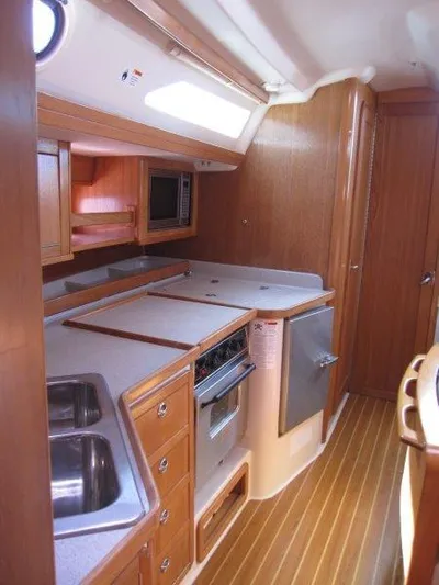  Yacht Photos Pics 2007 Catalina MkII yacht interior kitchen with wooden cabinetry and modern appliances.
