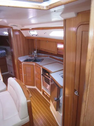  Yacht Photos Pics 2007 Catalina MkII yacht interior with modern kitchen and wooden cabinetry.