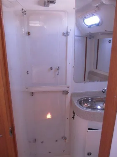  Yacht Photos Pics 2007 Catalina MkII bathroom with shower, sink, and porthole window.