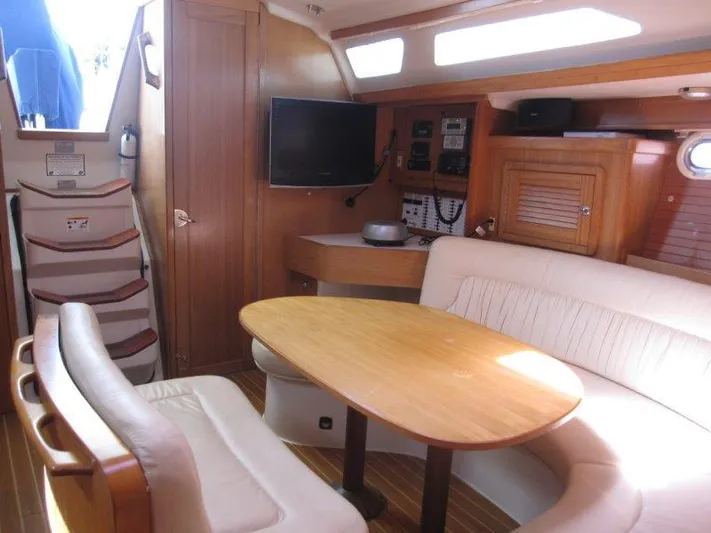  Yacht Photos Pics Interior of a 2007 Catalina MkII sailboat with a cozy dining area and navigation equipment.