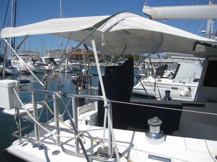  Yacht Photos Pics 2007 Catalina MkII sailboat docked in a marina with a sunshade canopy.