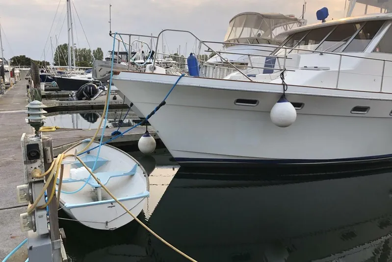  Yacht Photos Pics 1985 Bayliner 4550 Motoryacht docked at marina with small boat alongside.