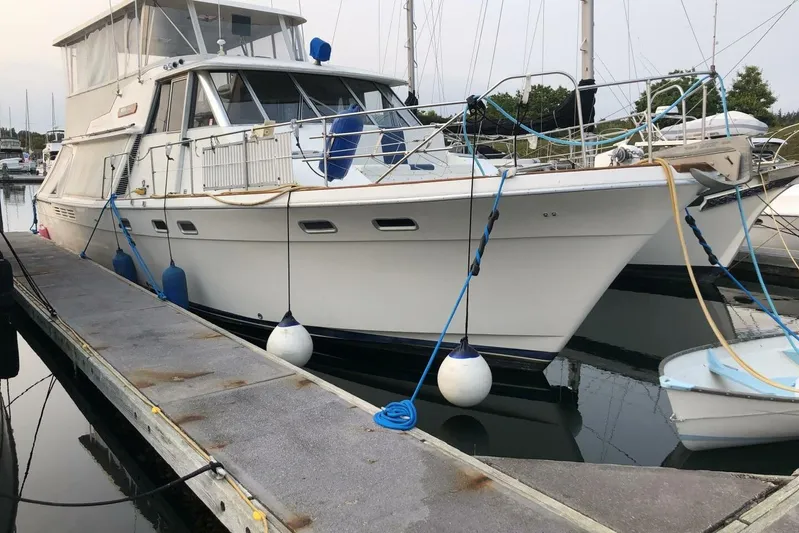 Yacht Photos Pics 1985 Bayliner 4550 Motoryacht docked at marina with fenders and ropes.