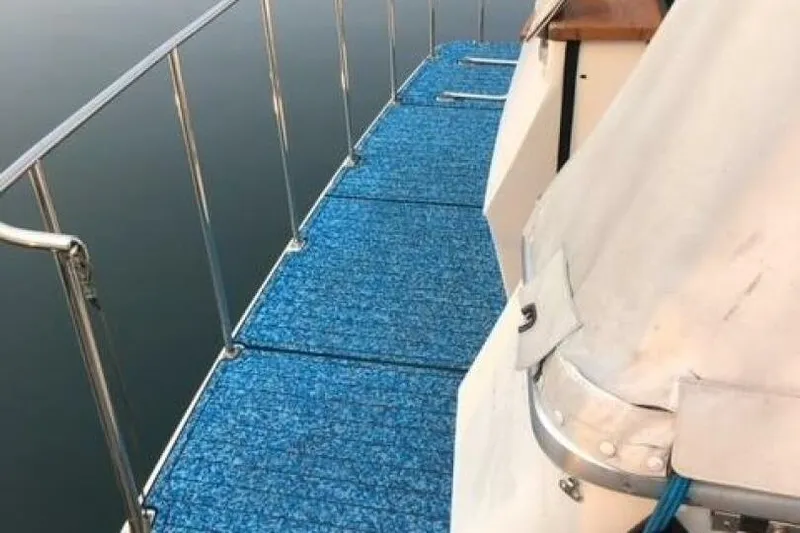  Yacht Photos Pics 1985 Bayliner 4550 Motoryacht deck with blue carpeting and railing.
