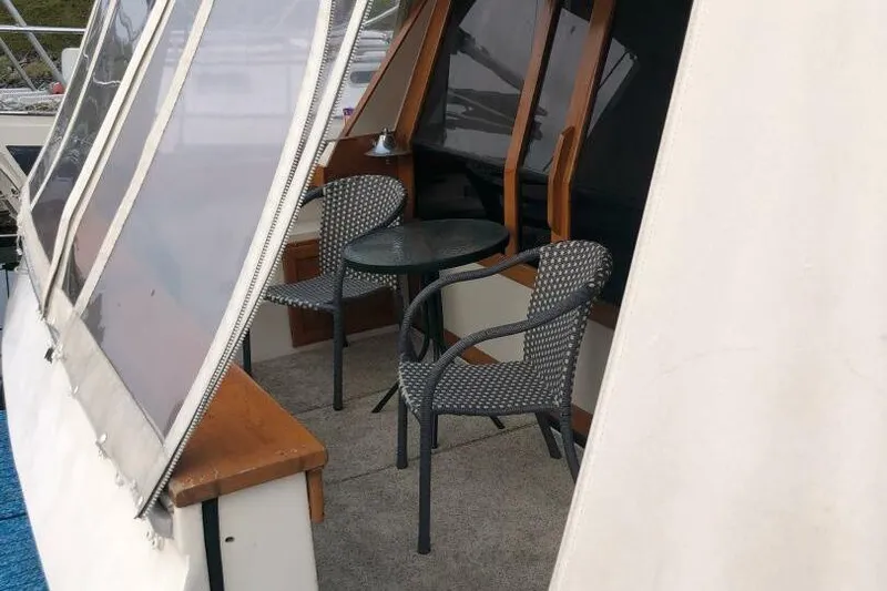  Yacht Photos Pics 1985 Bayliner 4550 Motoryacht deck with chairs and table under canopy.