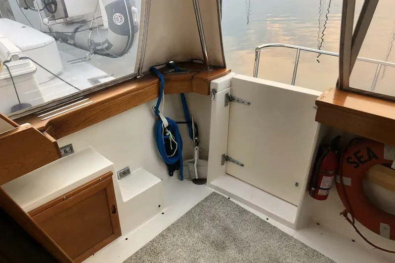  Yacht Photos Pics 1985 Bayliner 4550 Motoryacht interior with safety equipment and wooden cabinetry.