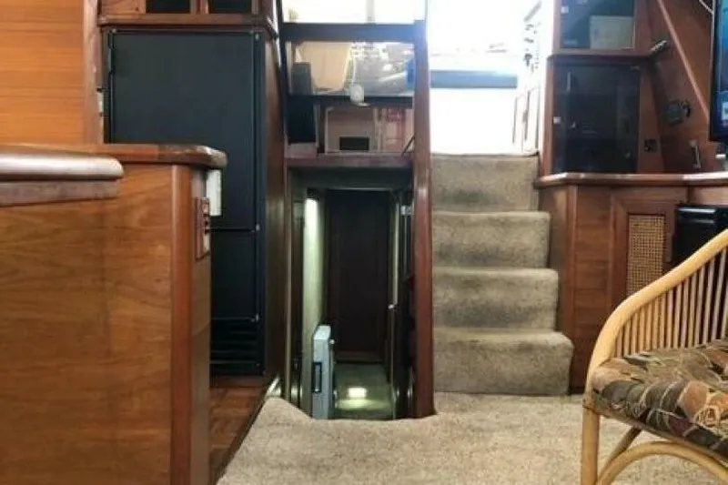  Yacht Photos Pics Interior of 1985 Bayliner 4550 Motoryacht with wooden cabinetry and carpeted stairs.