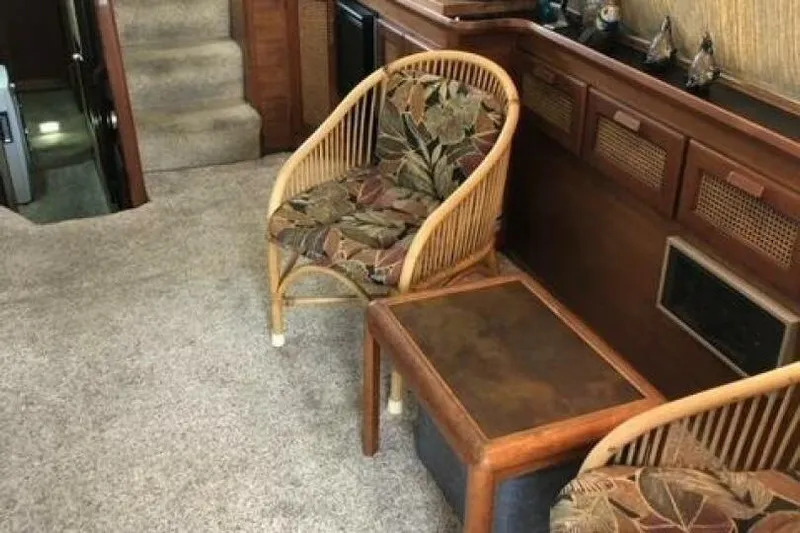  Yacht Photos Pics Interior of 1985 Bayliner 4550 Motoryacht with wicker chairs and wooden table.