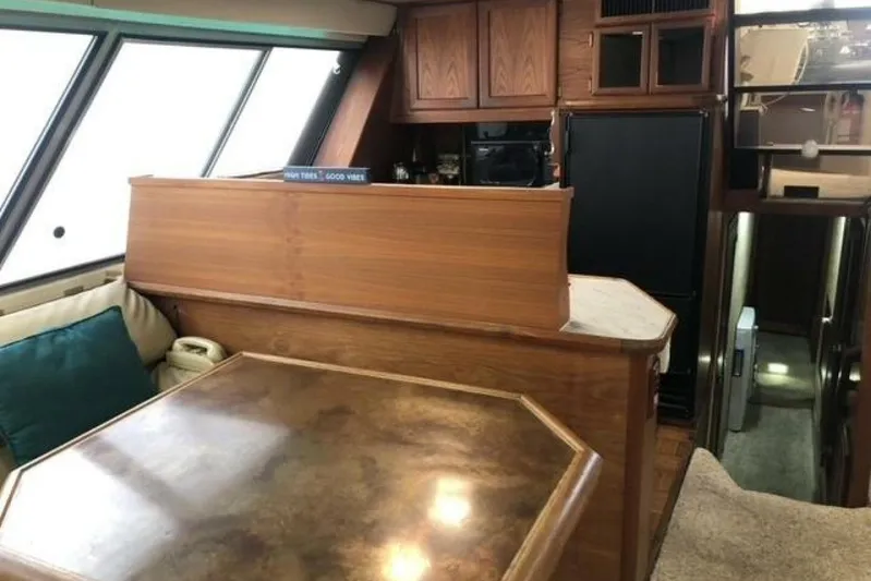  Yacht Photos Pics Interior of 1985 Bayliner 4550 Motoryacht with wood cabinetry and seating area.