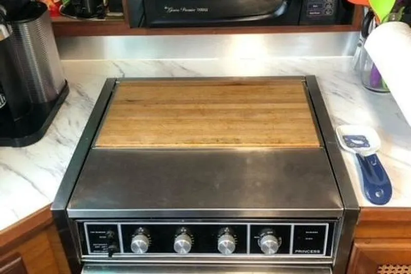  Yacht Photos Pics Stove with wooden cover in 1985 Bayliner 4550 Motoryacht kitchen.