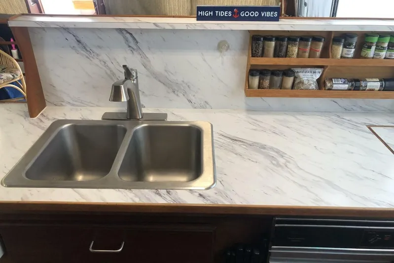  Yacht Photos Pics Modern kitchen in 1985 Bayliner 4550 Motoryacht with marble countertop and spice rack.