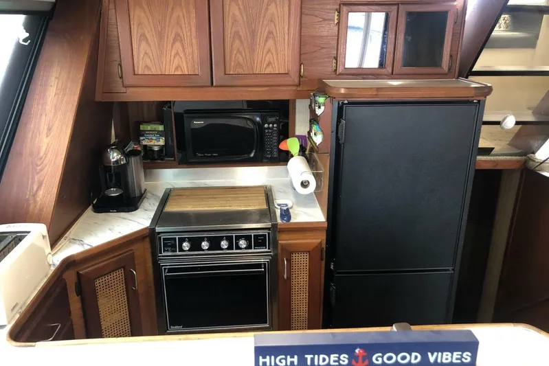  Yacht Photos Pics 1985 Bayliner 4550 Motoryacht kitchen with stove, microwave, and refrigerator.