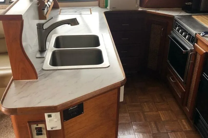  Yacht Photos Pics 1985 Bayliner 4550 Motoryacht kitchen with dual sinks and wooden cabinetry.