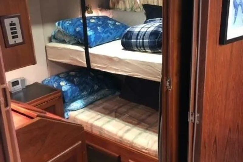  Yacht Photos Pics Cozy cabin interior of 1985 Bayliner 4550 Motoryacht with bunk beds and wooden furnishings.