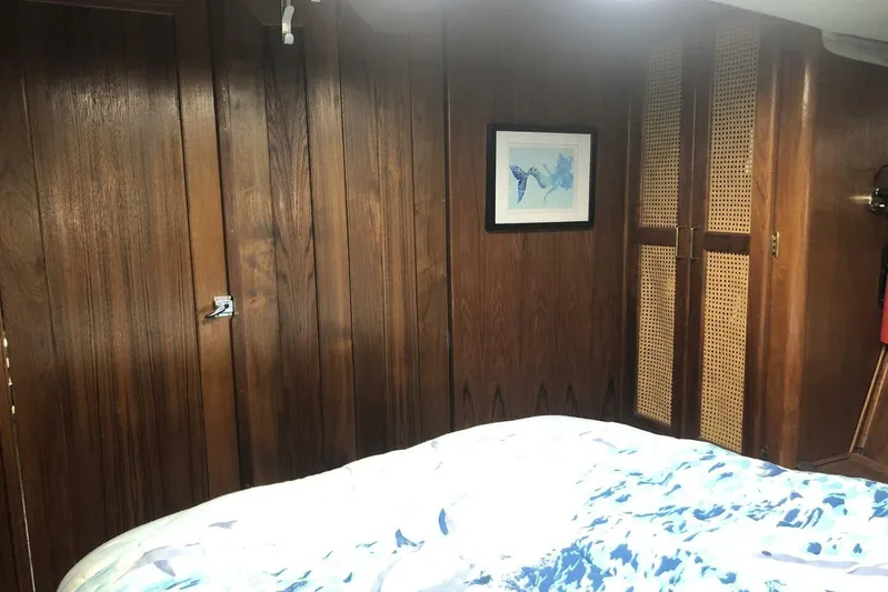  Yacht Photos Pics Interior of 1985 Bayliner 4550 Motoryacht with wood paneling and framed artwork.