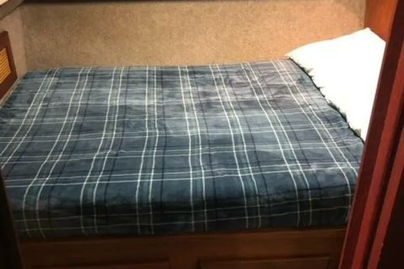  Yacht Photos Pics Cozy cabin bed in 1985 Bayliner 4550 Motoryacht with plaid bedding.