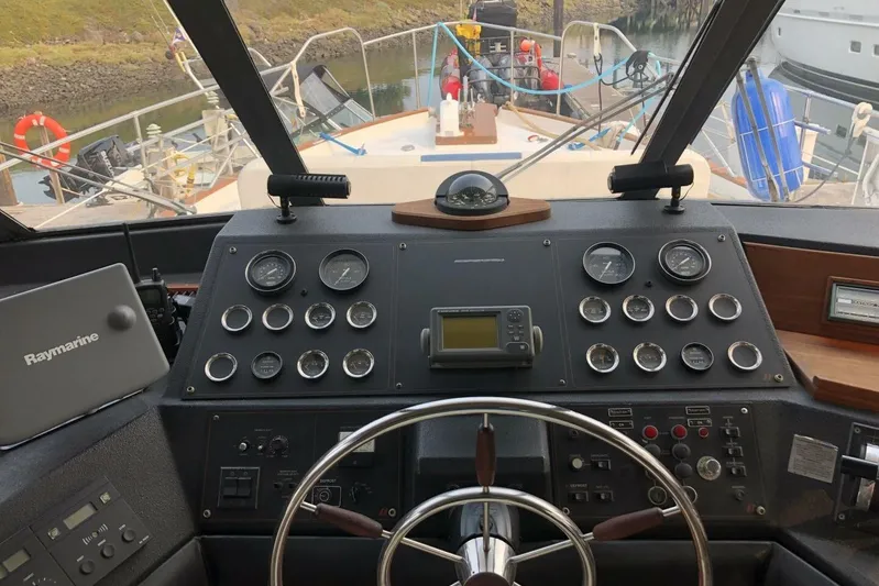  Yacht Photos Pics Cockpit of 1985 Bayliner 4550 Motoryacht with navigation instruments and steering wheel.