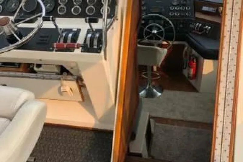  Yacht Photos Pics Interior view of 1985 Bayliner 4550 Motoryacht helm with steering wheel and control panels.