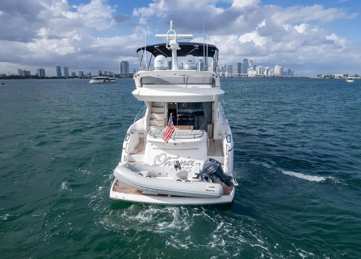 Ohana Yacht Photos Pics 2016 Sunseeker Manhattan 55 yacht on open water with city skyline backdrop.