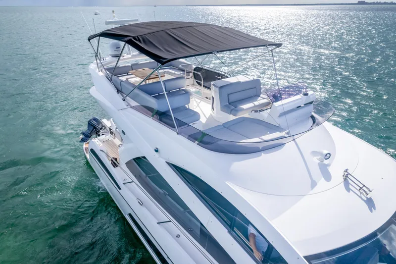 Ohana Yacht Photos Pics 2016 Sunseeker Manhattan 55 yacht cruising on open water, featuring sleek design and spacious deck.