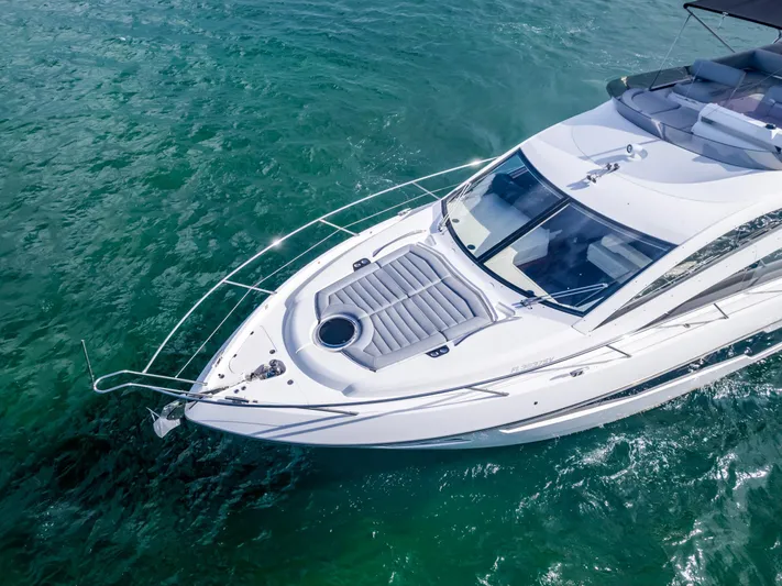 Ohana Yacht Photos Pics Sunseeker Manhattan 55 yacht cruising on clear turquoise water, aerial view, 2016 model.