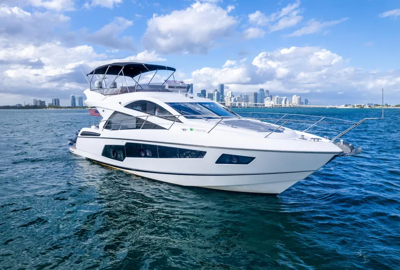 Ohana Yacht Photos Pics 2016 Sunseeker Manhattan 55 yacht cruising on open water with city skyline backdrop.
