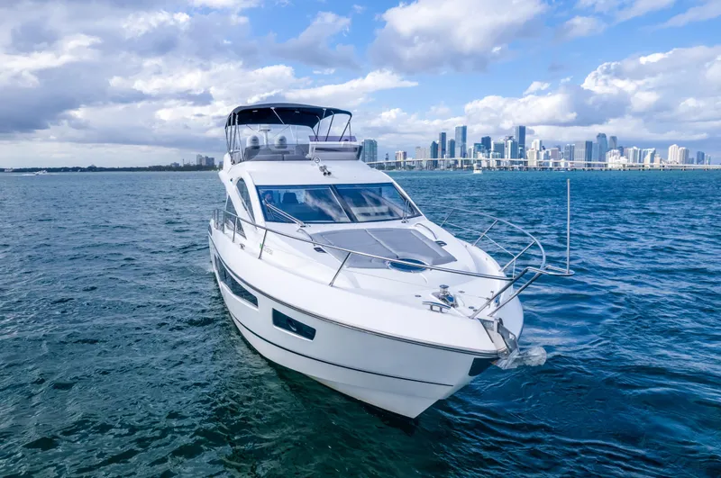 Ohana Yacht Photos Pics 2016 Sunseeker Manhattan 55 yacht cruising on open water with city skyline backdrop.