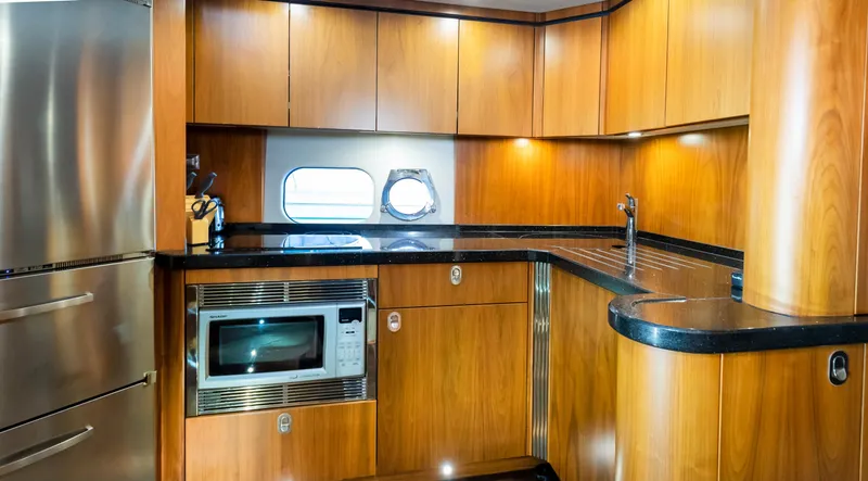 Ohana Yacht Photos Pics Luxurious kitchen interior of 2016 Sunseeker Manhattan 55 yacht with modern appliances.