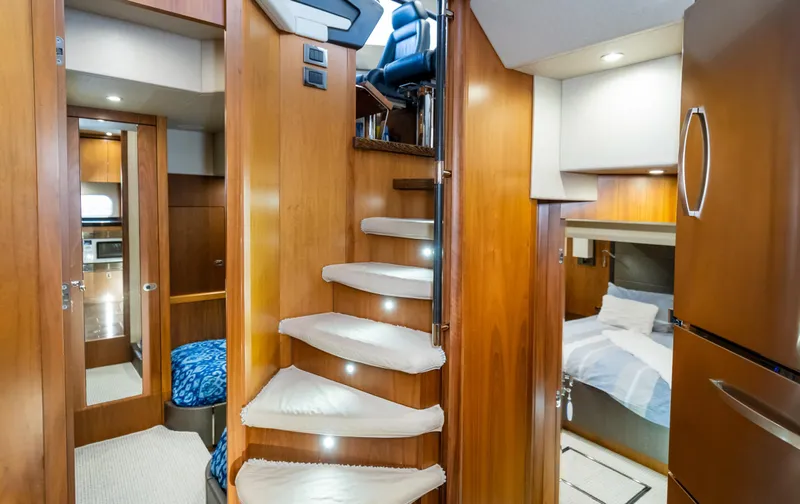 Ohana Yacht Photos Pics Luxurious interior of 2016 Sunseeker Manhattan 55 yacht with wooden stairs and cozy cabins.