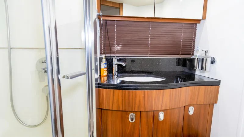 Ohana Yacht Photos Pics Luxurious bathroom in 2016 Sunseeker Manhattan 55 yacht with modern fixtures and wood accents.
