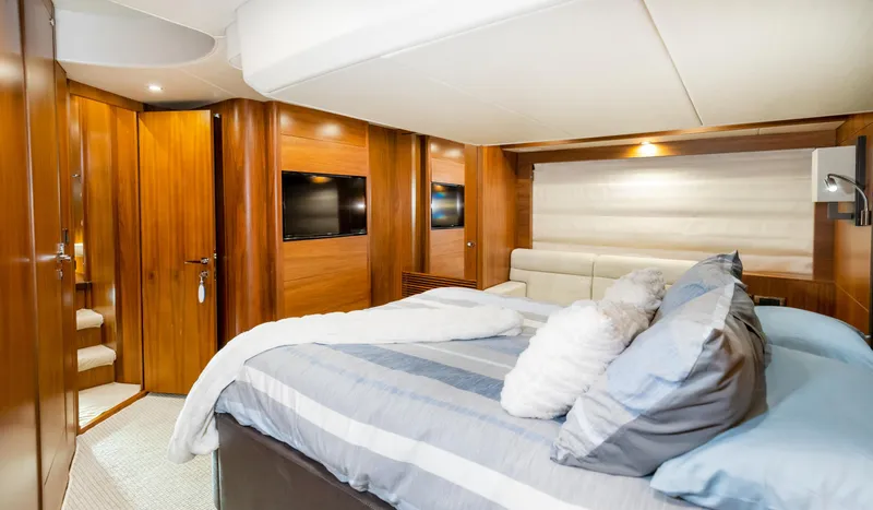 Ohana Yacht Photos Pics Luxurious bedroom interior of 2016 Sunseeker Manhattan 55 yacht with modern wood finishes.