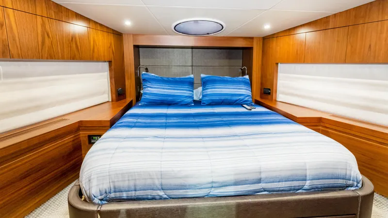 Ohana Yacht Photos Pics Luxurious cabin interior of 2016 Sunseeker Manhattan 55 yacht with blue bedding.