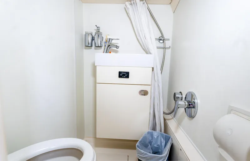 Ohana Yacht Photos Pics Bathroom interior of 2016 Sunseeker Manhattan 55 yacht, featuring sink, shower, and toilet.