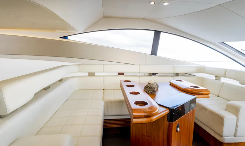 Ohana Yacht Photos Pics Luxurious interior of 2016 Sunseeker Manhattan 55 yacht with elegant seating and wooden table.