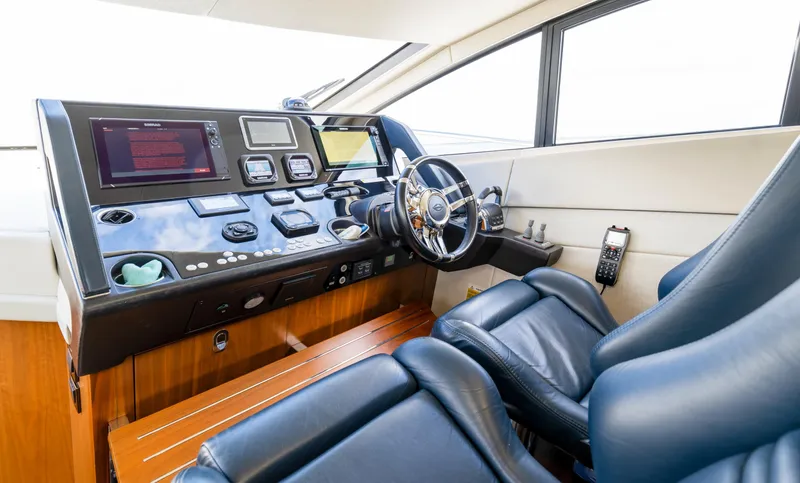 Ohana Yacht Photos Pics Cockpit of 2016 Sunseeker Manhattan 55 yacht with modern controls and leather seating.