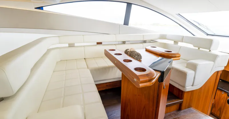 Ohana Yacht Photos Pics Luxurious interior of 2016 Sunseeker Manhattan 55 yacht with elegant seating and wooden accents.