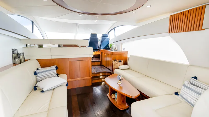 Ohana Yacht Photos Pics Luxurious interior of 2016 Sunseeker Manhattan 55 yacht with elegant seating and wooden accents.
