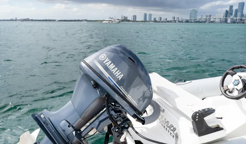 Ohana Yacht Photos Pics Yamaha outboard motor on a Sunseeker Manhattan 55, 2016, with city skyline in background.