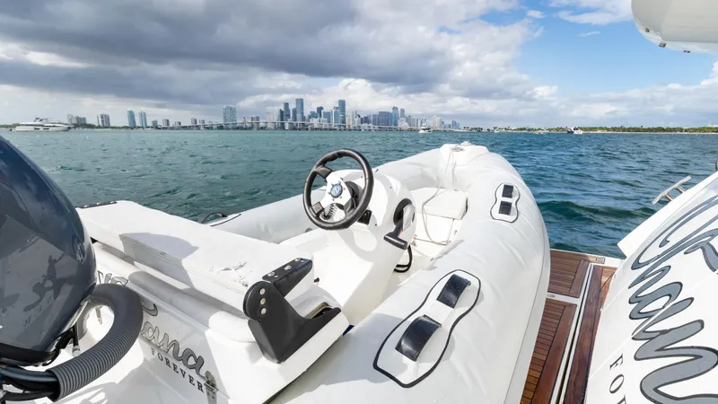 Ohana Yacht Photos Pics Sunseeker Manhattan 55 yacht, 2016 model, with city skyline in the background.